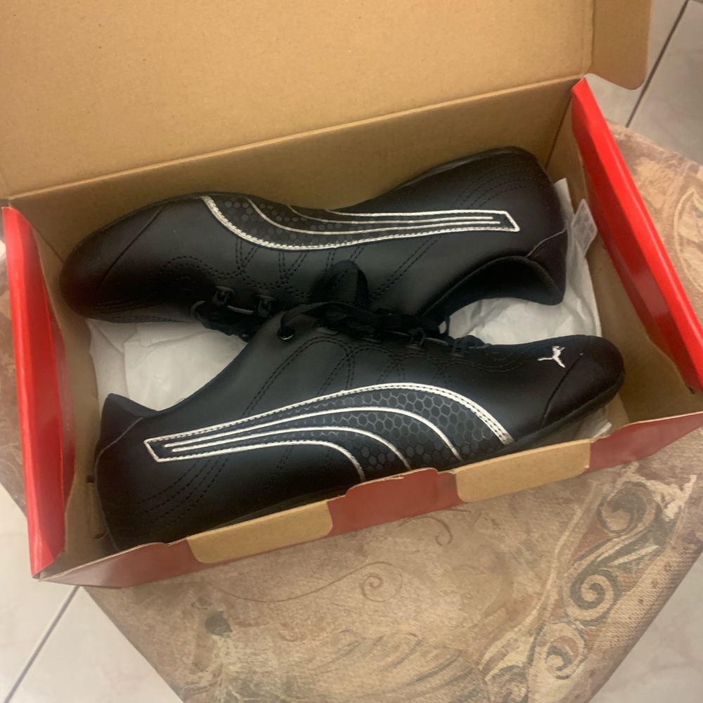 Black leather pumas